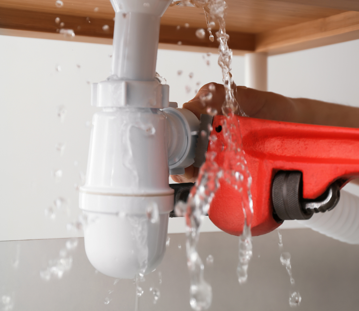 Drain trap repair beneath a sink